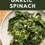 A plate of sautéed garlic spinach flecked with flaky sea salt.