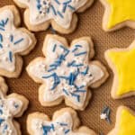 Star and snowflake shaped gluten-free sugar cookie cut outs with royal icing and sprinkles.