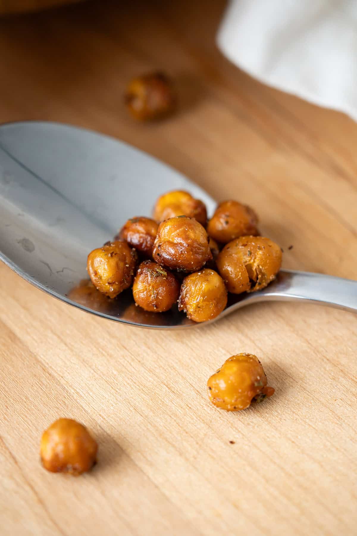 A close up of a spoonful of crispy roasted chickpeas to show their super crunchy texture.