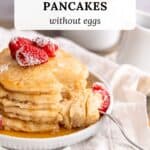 A stack of gluten-free pancakes with a bite removed to show the fluffy middles.