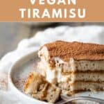 A slice of vegan tiramisu with layers of vegan ladyfingers and creamy vegan custard.