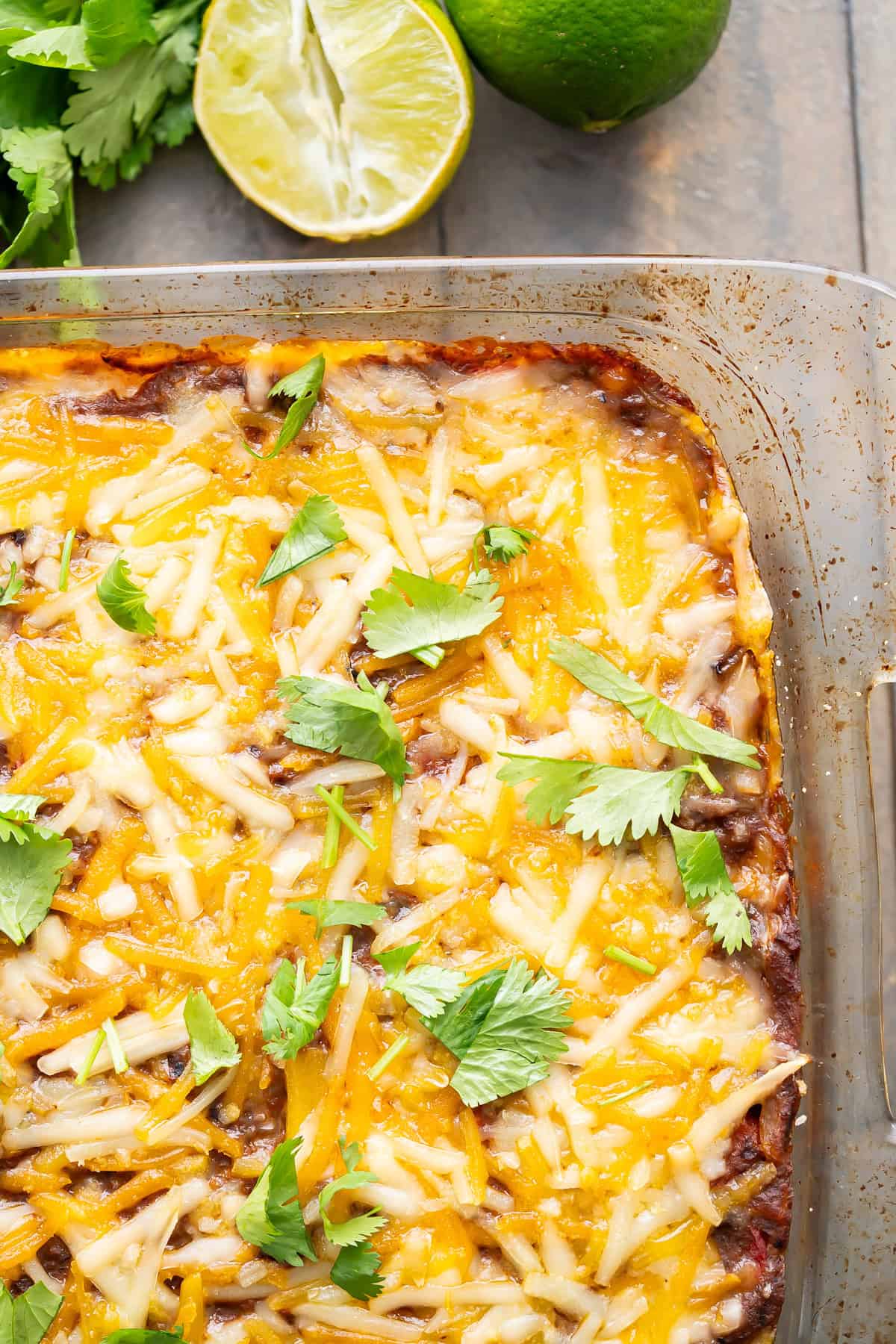 Close up of the melted cheese covering an enchilada casserole.
