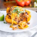 The inside of a stuffed quinoa bell pepper to show the layers and filling components.