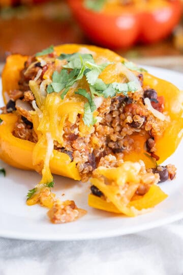 The inside of a stuffed quinoa bell pepper to show the layers and filling components.