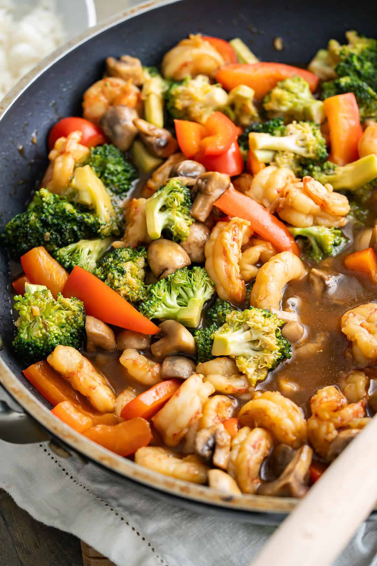 A luscious gluten-free stir fry sauce coating shrimp and vegetables.