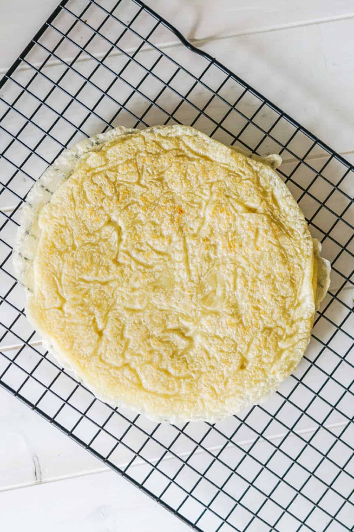 A stack of tapioca flour crepes on a cooling rack.