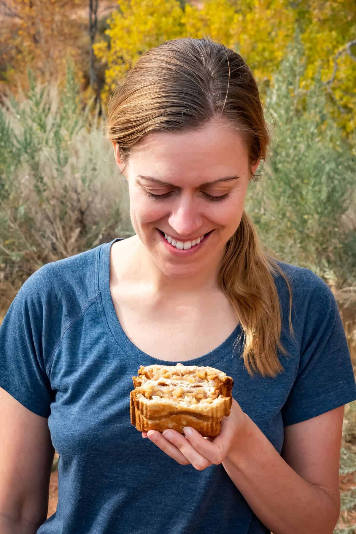 The author holding a pie iron apple pie at a campsite.