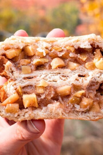 A campfire pie iron apple pie split in half to show the crispy outer "crust" and apple filling.