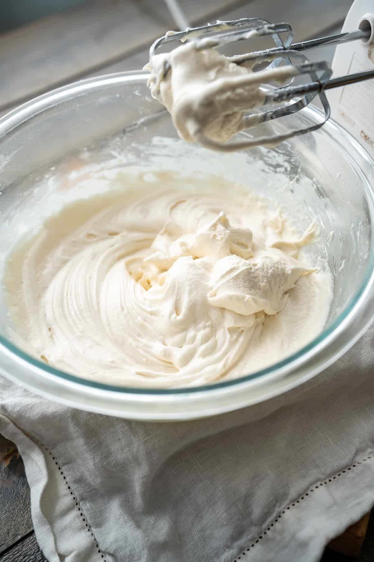 A bowl of fluffy dairy-free cream cheese frosting.