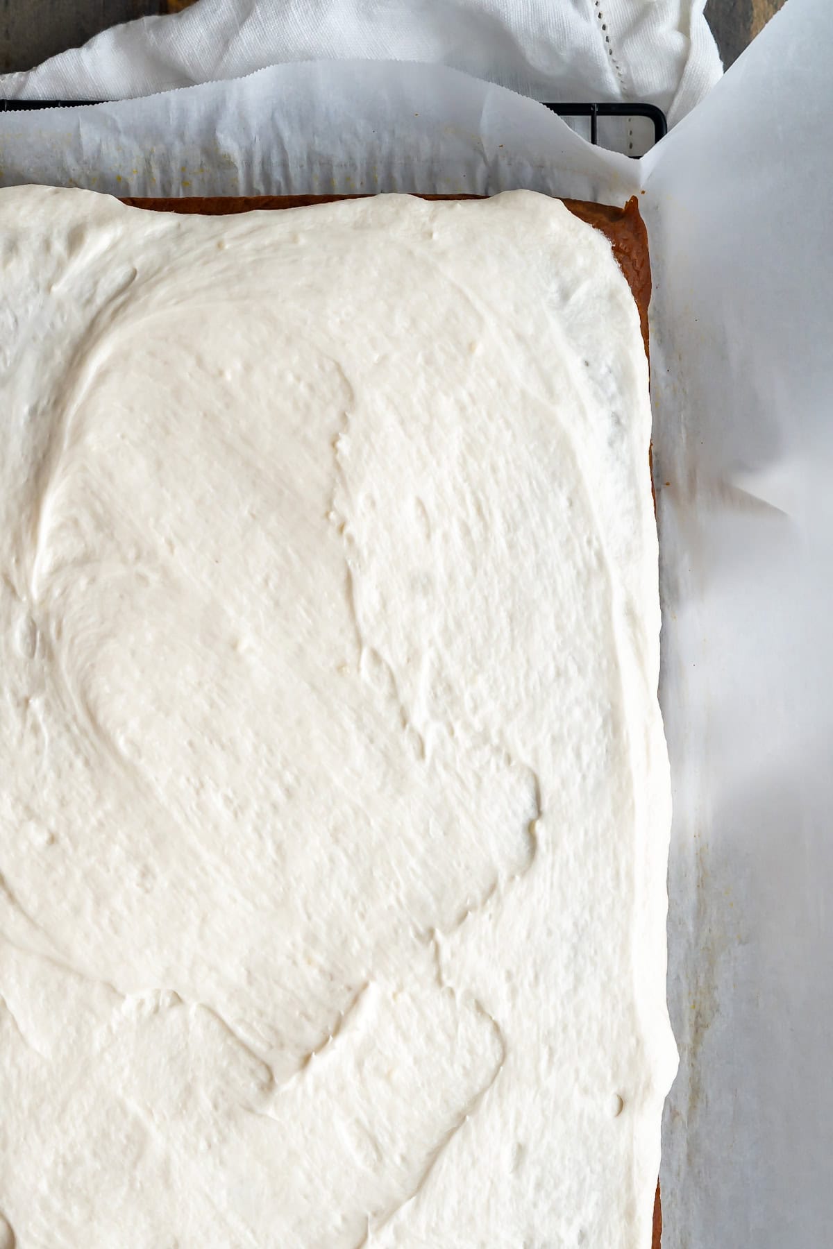Dairy-free cream cheese frosting smeared across pumpkin bars.