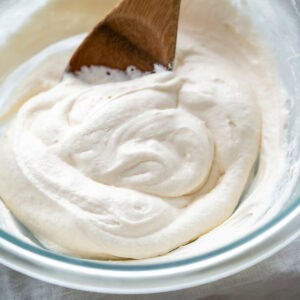 Creamy dairy-Free cream cheese frosting swirled in a bowl.