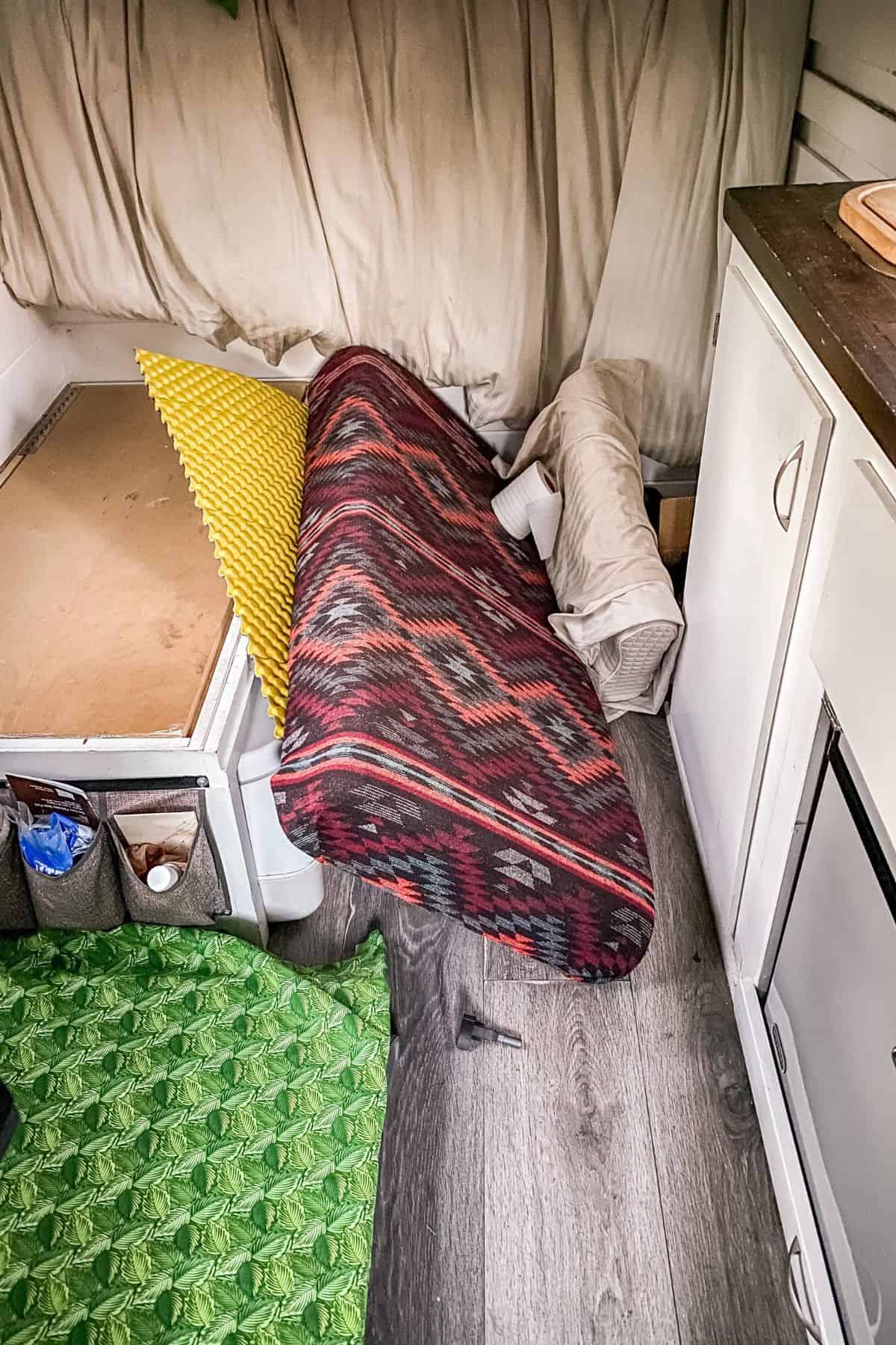 The back of a camper van with items tossed everywhere.