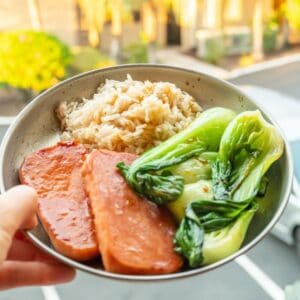 A spam musubi bowl with cooked rice, bok choy, and marinated spam.
