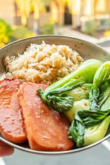 A spam musubi bowl with cooked rice, bok choy, and marinated spam.