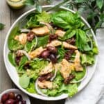 Chicken, olives, and sun-dried tomato on a bed of greens with a rich tuscan dressing.