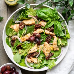 Chicken, olives, and sun-dried tomato on a bed of greens with a rich tuscan dressing.