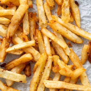 A close up of golden, extra crispy french fries.