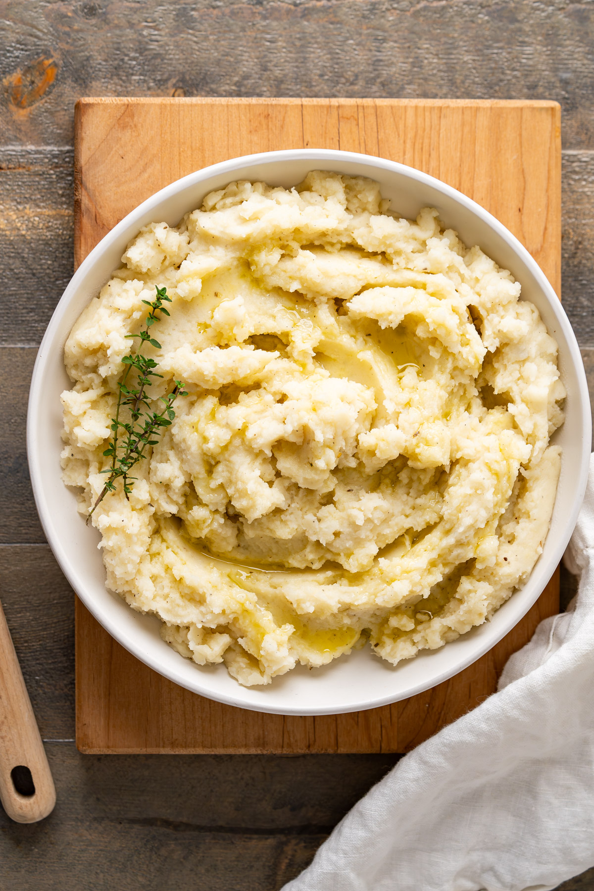 A serving plate of creamy dairy-free mashed potatoes with coconut milk showing its fluffy and creamy classic texture.