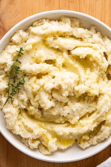 A serving dish of creamy dairy-free mashed potatoes with coconut milk.